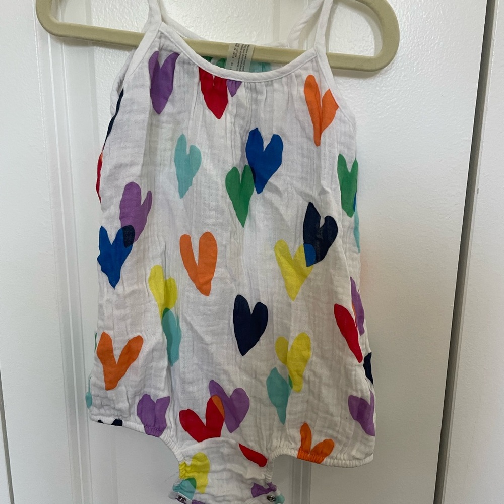 Primary never worn 12-18 month cotton rainbow heart romper.